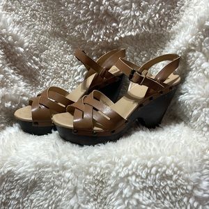 Deep tan color platforms with adjustable straps. A little scuffed in front.